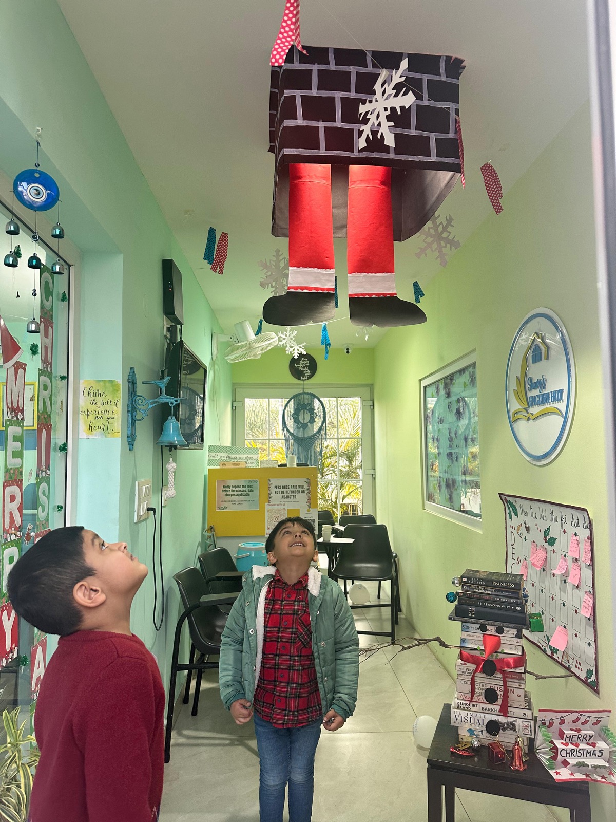 Students admiring a hanging Santa decoration in the classroom