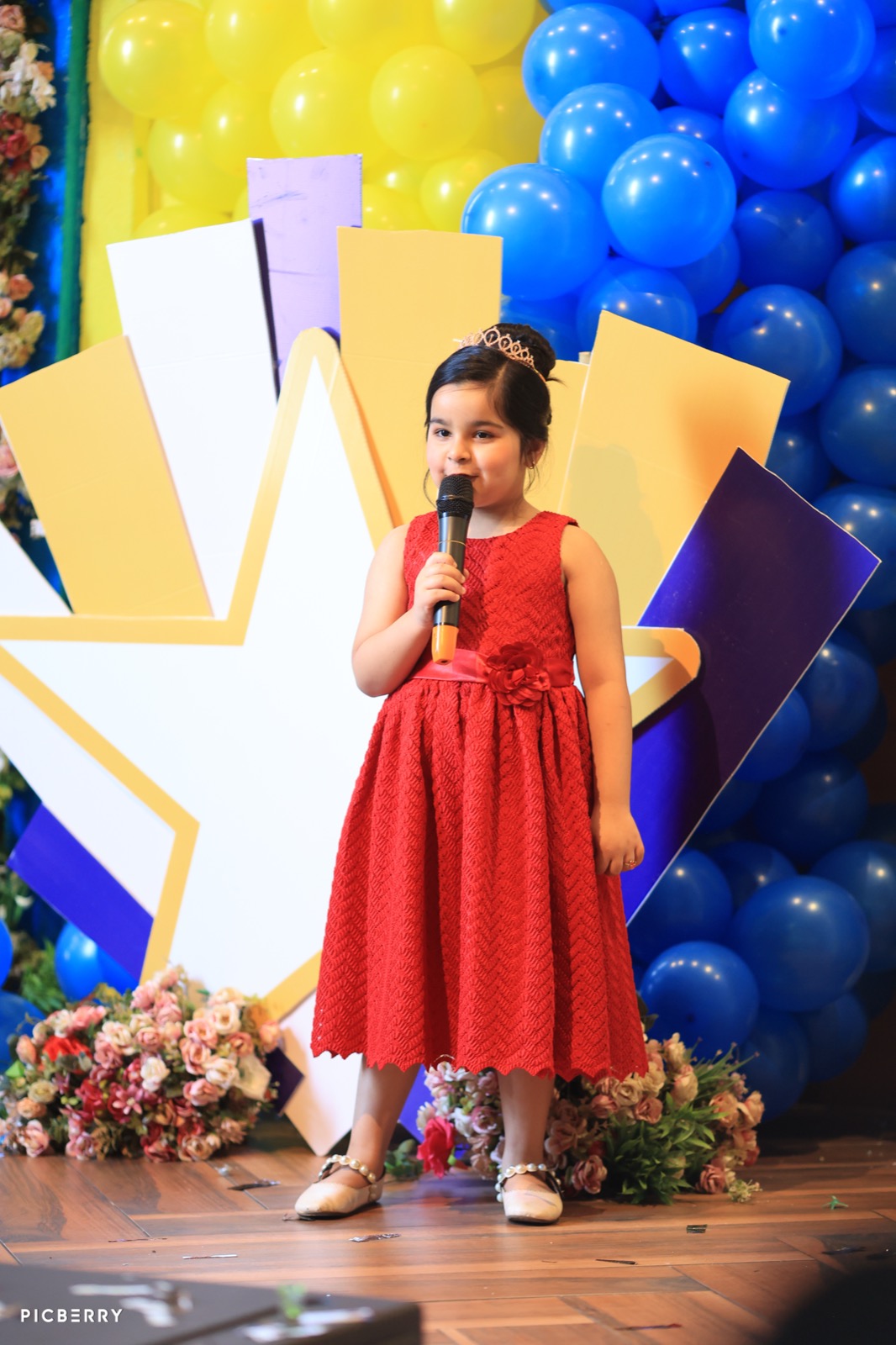 Student in a red dress presenting at Entrepreneurship Day