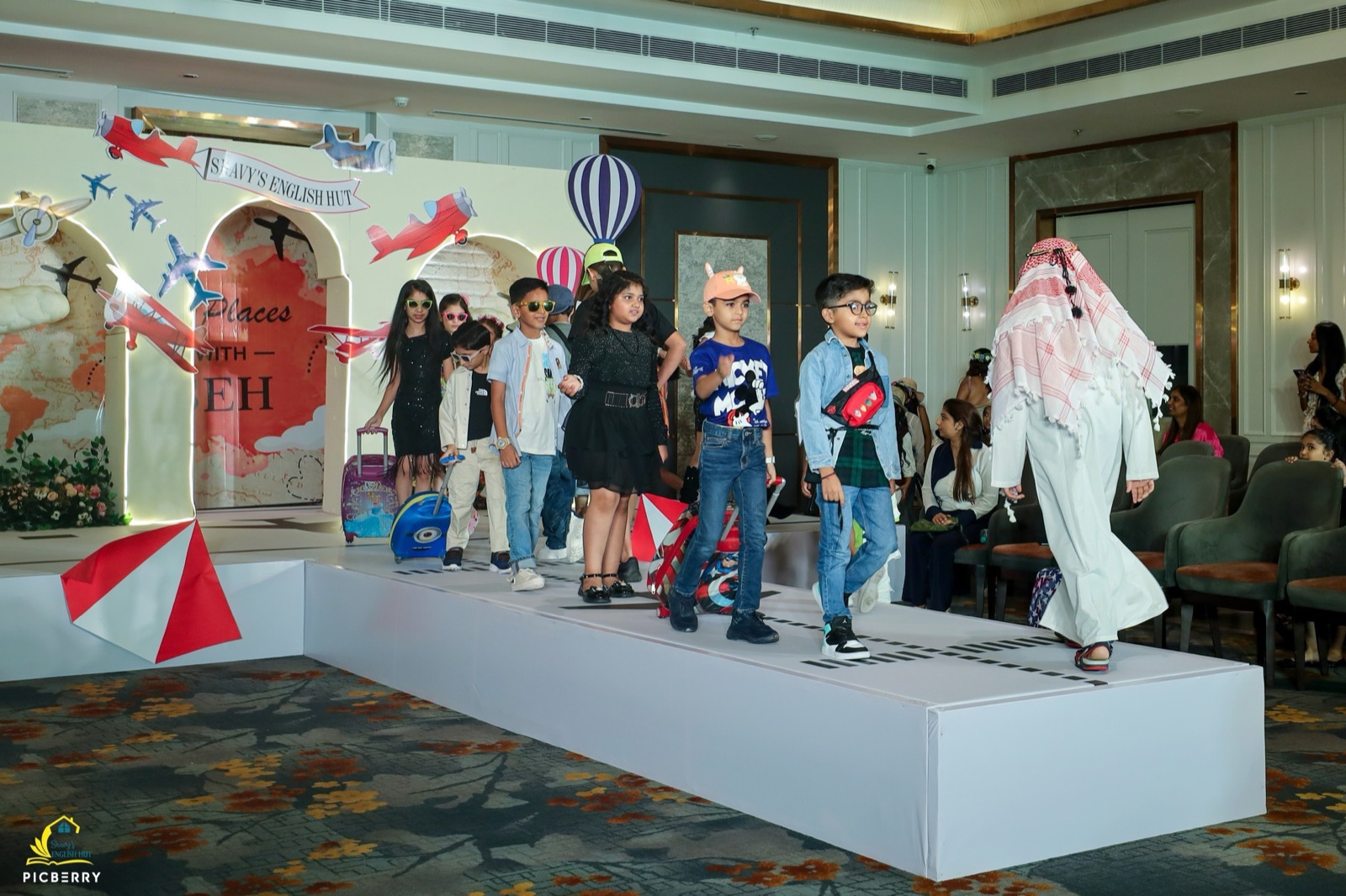 Group of students on stage at a Shavy's English Hut workshop