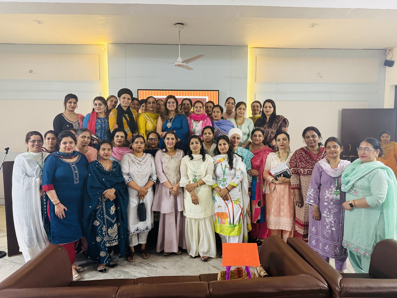 Coach Shavy with a large group at a women's workshop session